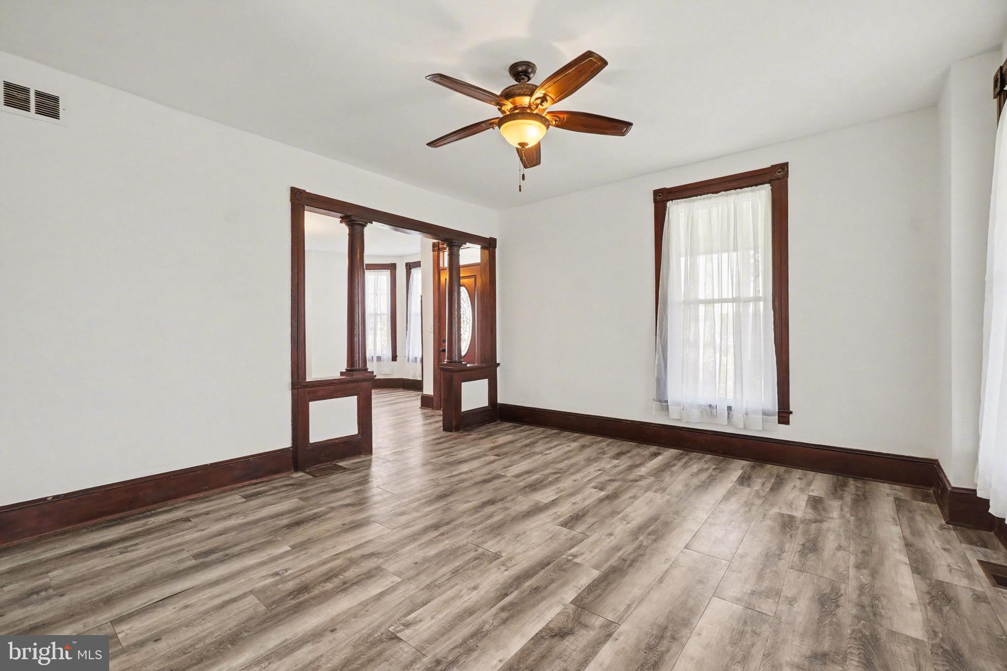 2322 Rock Spring Road Forest Hill, MD 21050 - Photo 7 of 39 an empty room with wooden floor chandelier fan and windows