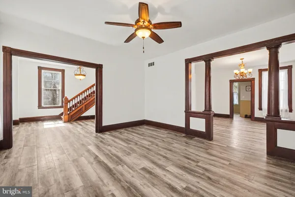 a view of empty room with wooden floor