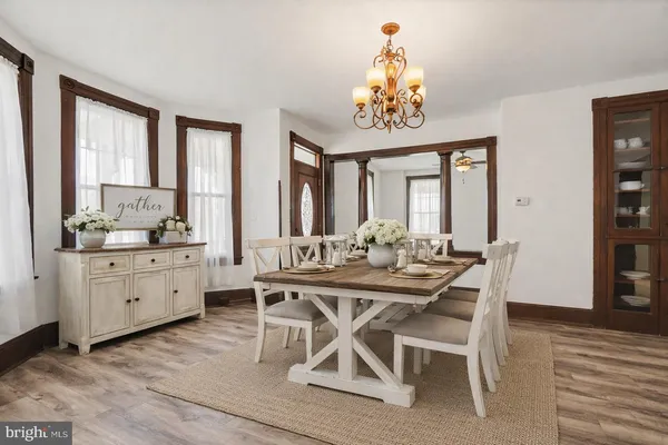a view of a dining room with furniture window and wooden floor