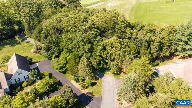 an aerial view of residential house with swimming pool and lawn chairs