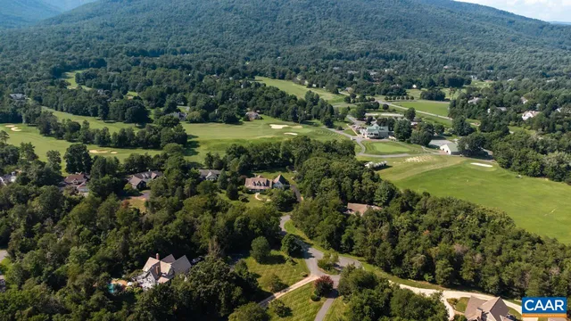 a view of a lush green hillside and houses