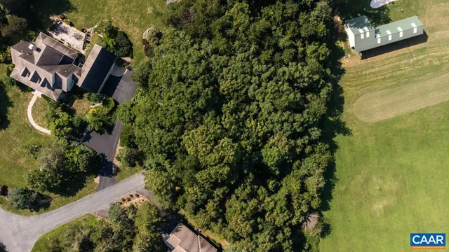 an aerial view of a house with a yard swimming pool outdoor seating and yard