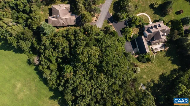 an aerial view of a house with a swimming pool