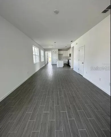 a view of a room with wooden floor and window
