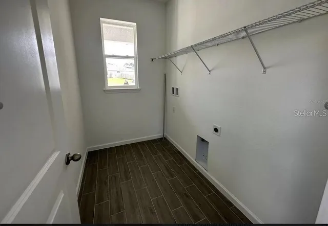 a view of a small space with wooden floor and windows