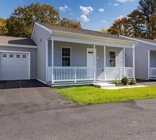 a front view of house with yard and outdoor seating