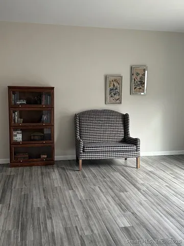 a living room with a bed furniture and a dresser