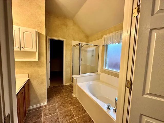 a bathroom with a tub and shower