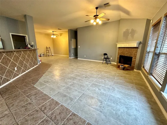 a view of a livingroom with a fireplace and a couch