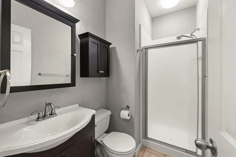 a bathroom with a sink toilet and mirror