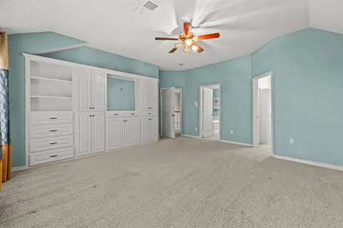 a view of an empty room with a ceiling fan