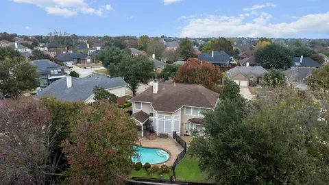 an aerial view of multiple houses with yard