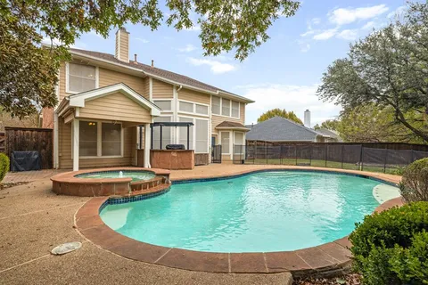 a view of a house with swimming pool and sitting area