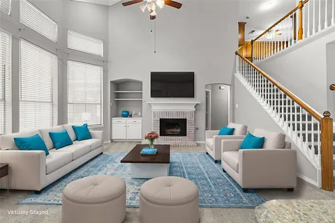 a living room with furniture a rug and a fireplace