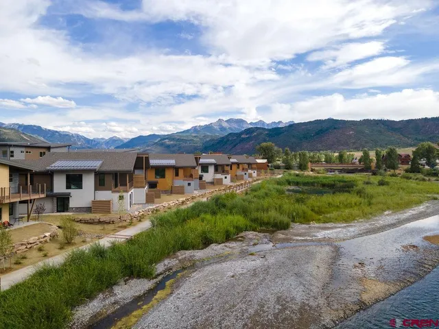 a kitchen with a table chairs refrigerator and cabinets