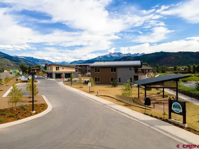 a front view of a house with a yard table and chairs