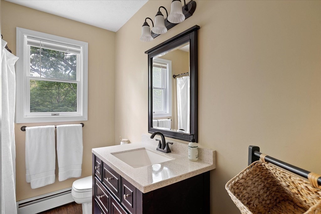 271 New Boston Road Sturbridge, MA 01566 - Photo 3 of 18 a bathroom with a sink a toilet and mirror