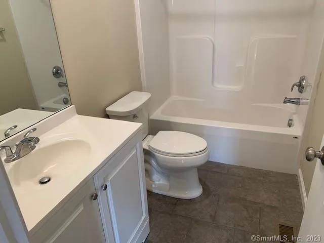 a white toilet sitting next to a bathroom sink