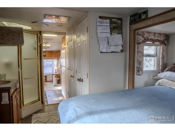 a bedroom with a bed and glass door