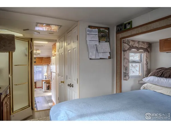 a bedroom with a bed and a large mirror