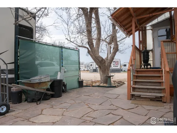 a backyard of a house with barbeque oven and outdoor seating