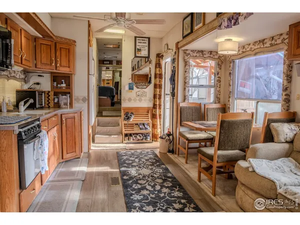 a living room with furniture a flat screen tv and next to a window