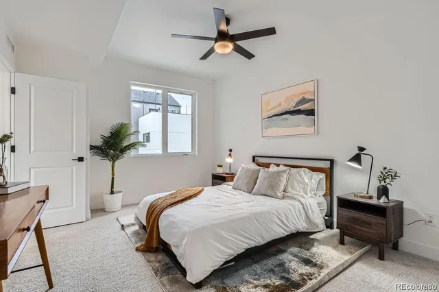 a bedroom with bed and a chandelier