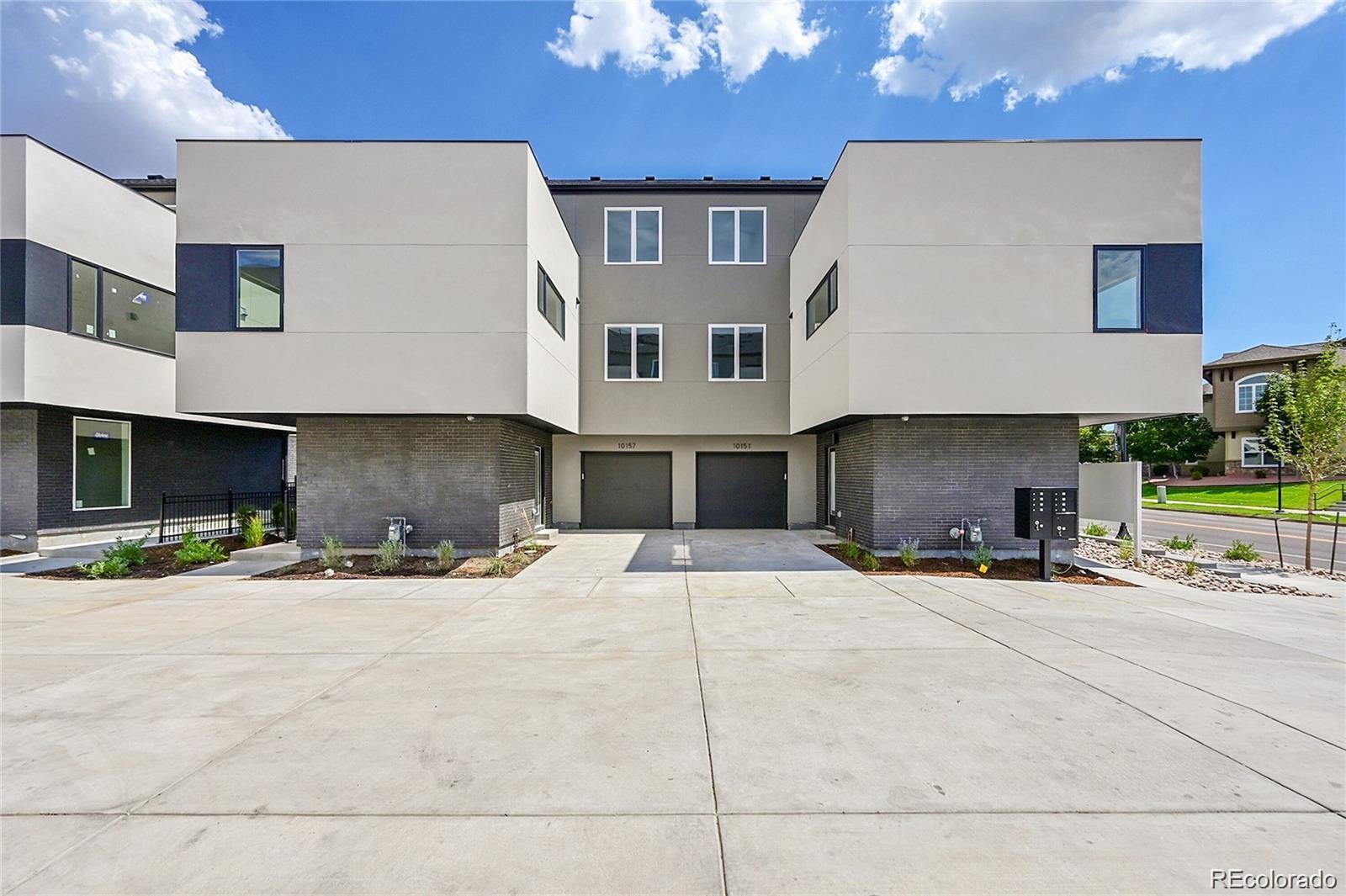 10151 West 38th Avenue Wheat Ridge, CO 80033 - Photo 25 of 50 a front view of a house with a yard and a garage