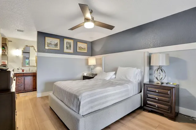 a bedroom with a bed and a chandelier