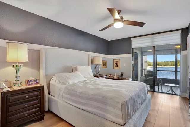 a bedroom with a large bed and a chandelier