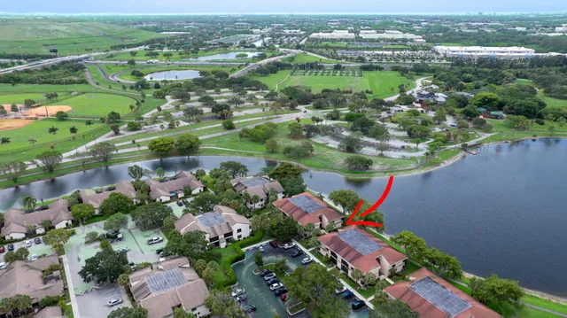 an aerial view of residential houses with outdoor space and pool