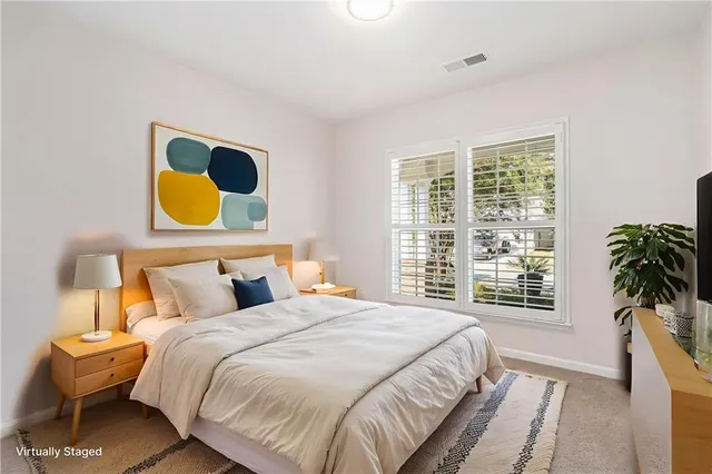 a bedroom with a bed and painting on the wall