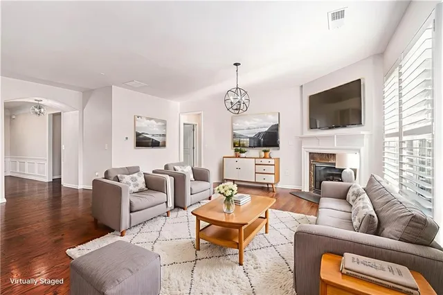 a living room with fireplace furniture and a flat screen tv
