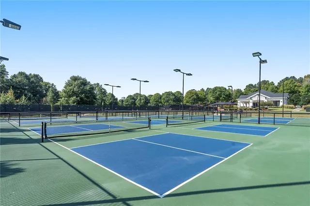 a view of swimming pool with outdoor space and trees in the background