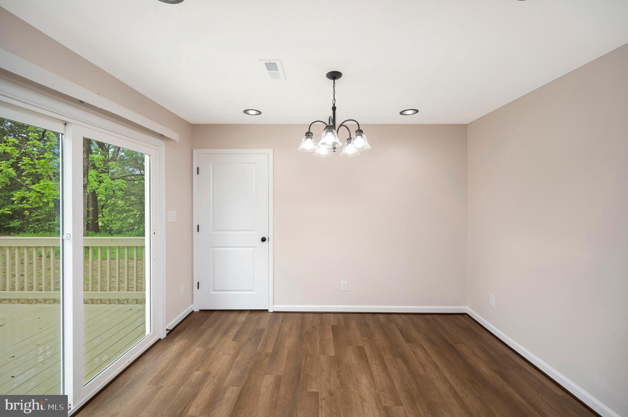 14169 Silver Hill Road Sumerduck, VA 22742 - Photo 11 of 40 a view of an empty room with wooden floor and a window