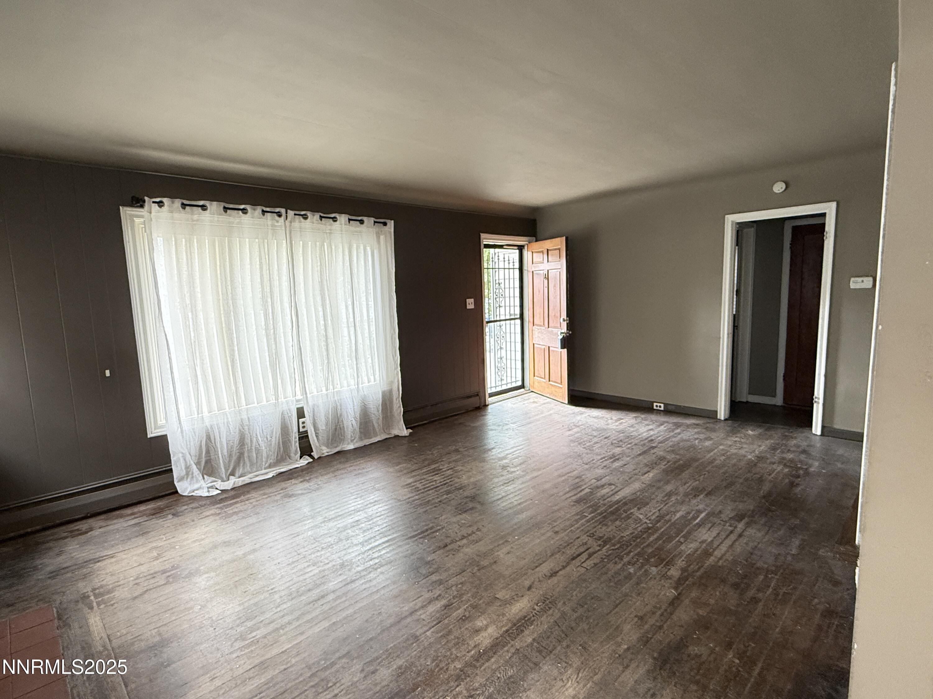 1170 Forest Street Reno, NV 89509 - Photo 12 of 32 an empty room with wooden floor and windows