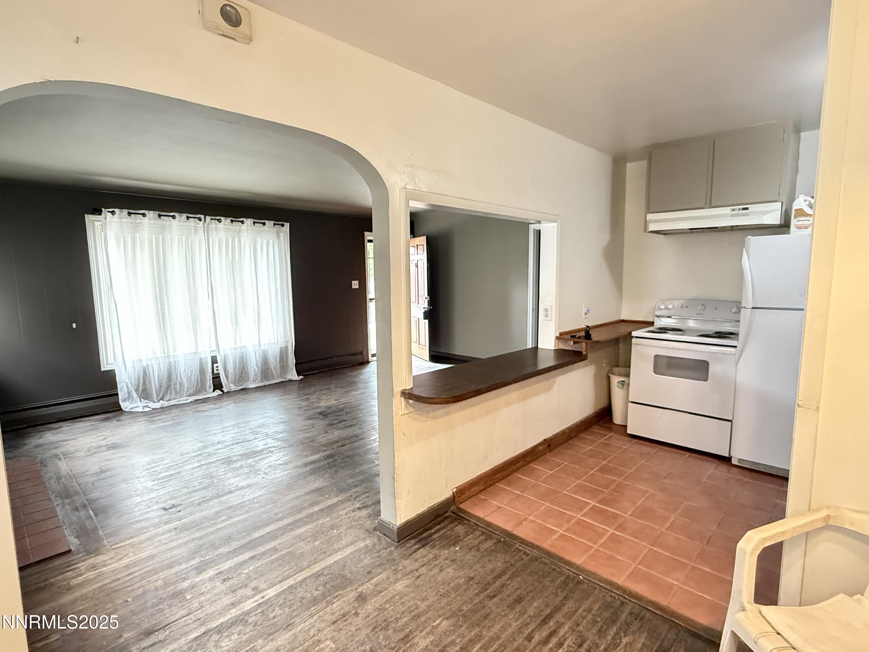 1170 Forest Street Reno, NV 89509 - Photo 2 of 32 a kitchen with granite countertop a stove and a refrigerator