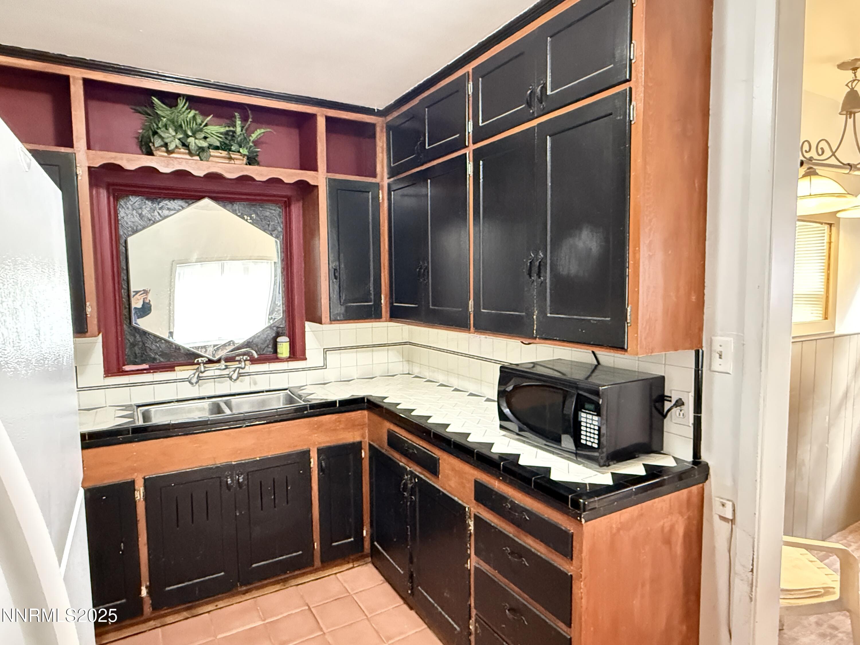 1170 Forest Street Reno, NV 89509 - Photo 3 of 32 a kitchen with a stove a sink and a window