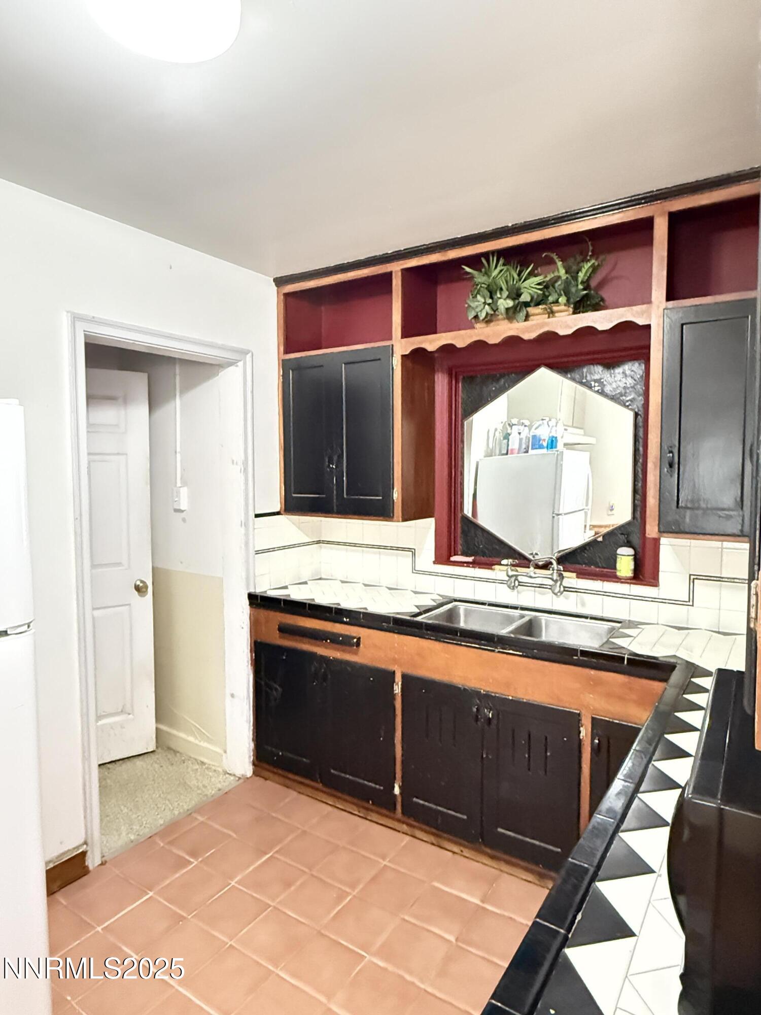 1170 Forest Street Reno, NV 89509 - Photo 5 of 32 a view of a kitchen with kitchen island a sink and a large window