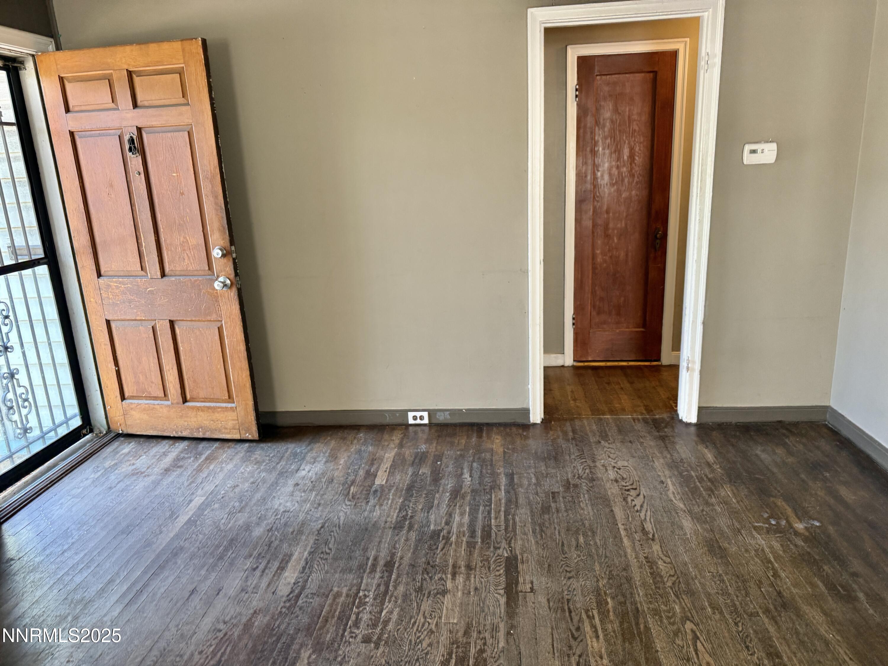 1170 Forest Street Reno, NV 89509 - Photo 8 of 32 an empty room with wooden floor and door