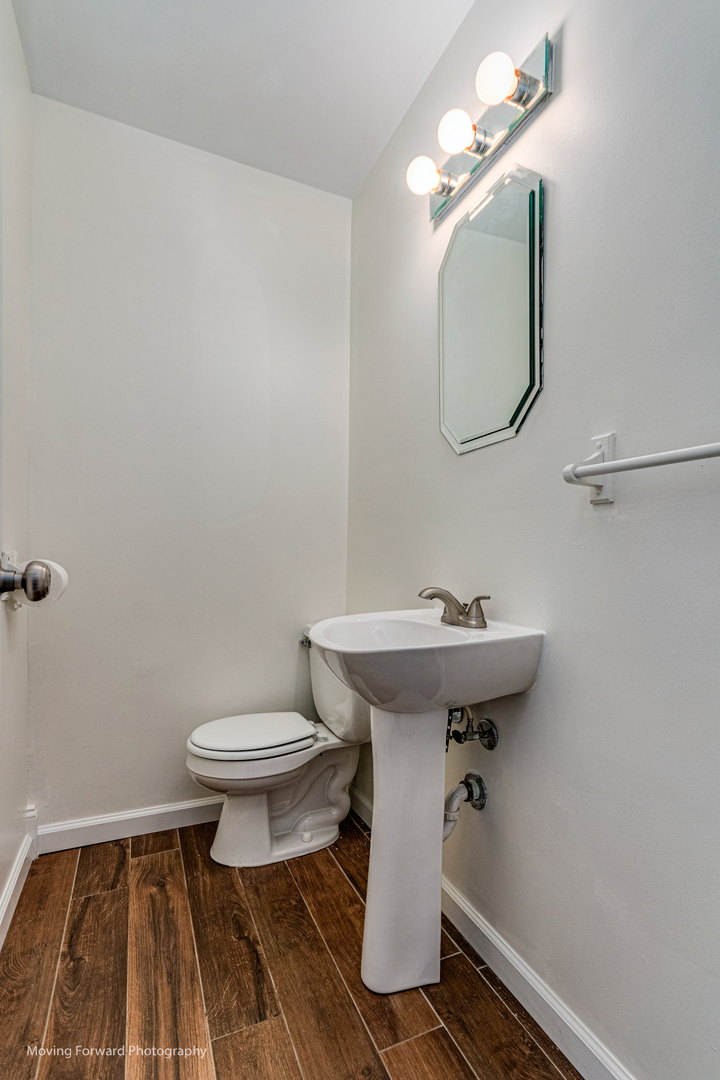 147 Queenswood Road Bolingbrook, IL 60440 - Photo 15 of 20 a bathroom with a sink toilet and a mirror