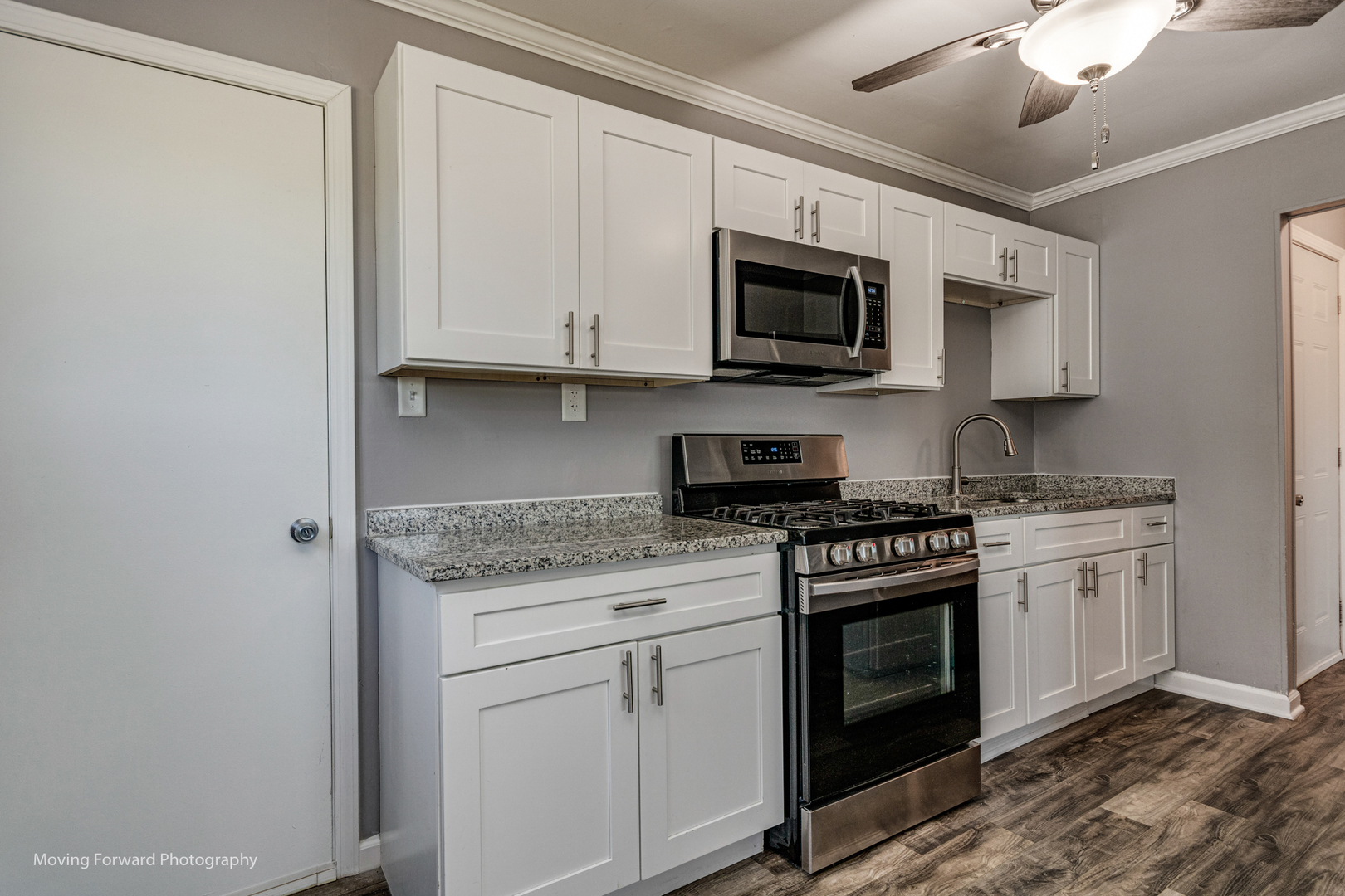 147 Queenswood Road Bolingbrook, IL 60440 - Photo 3 of 20 a kitchen with stainless steel appliances granite countertop white cabinets a sink a stove and a microwave