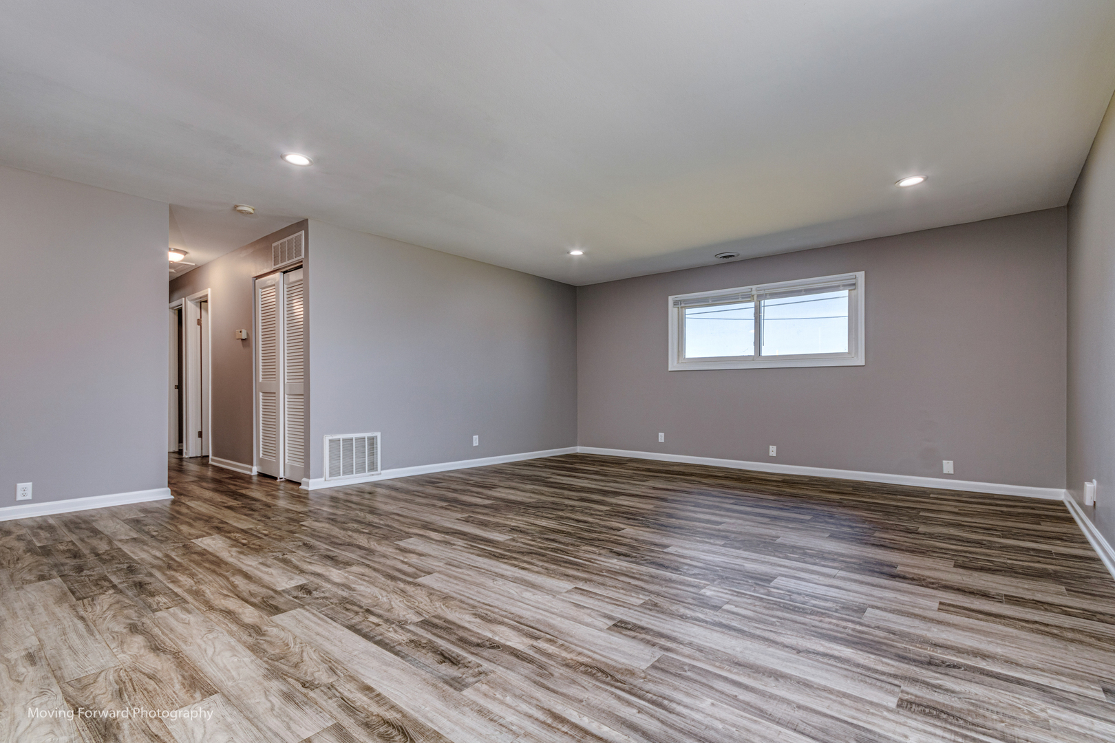 147 Queenswood Road Bolingbrook, IL 60440 - Photo 6 of 20 a view of an empty room with wooden floor and a window