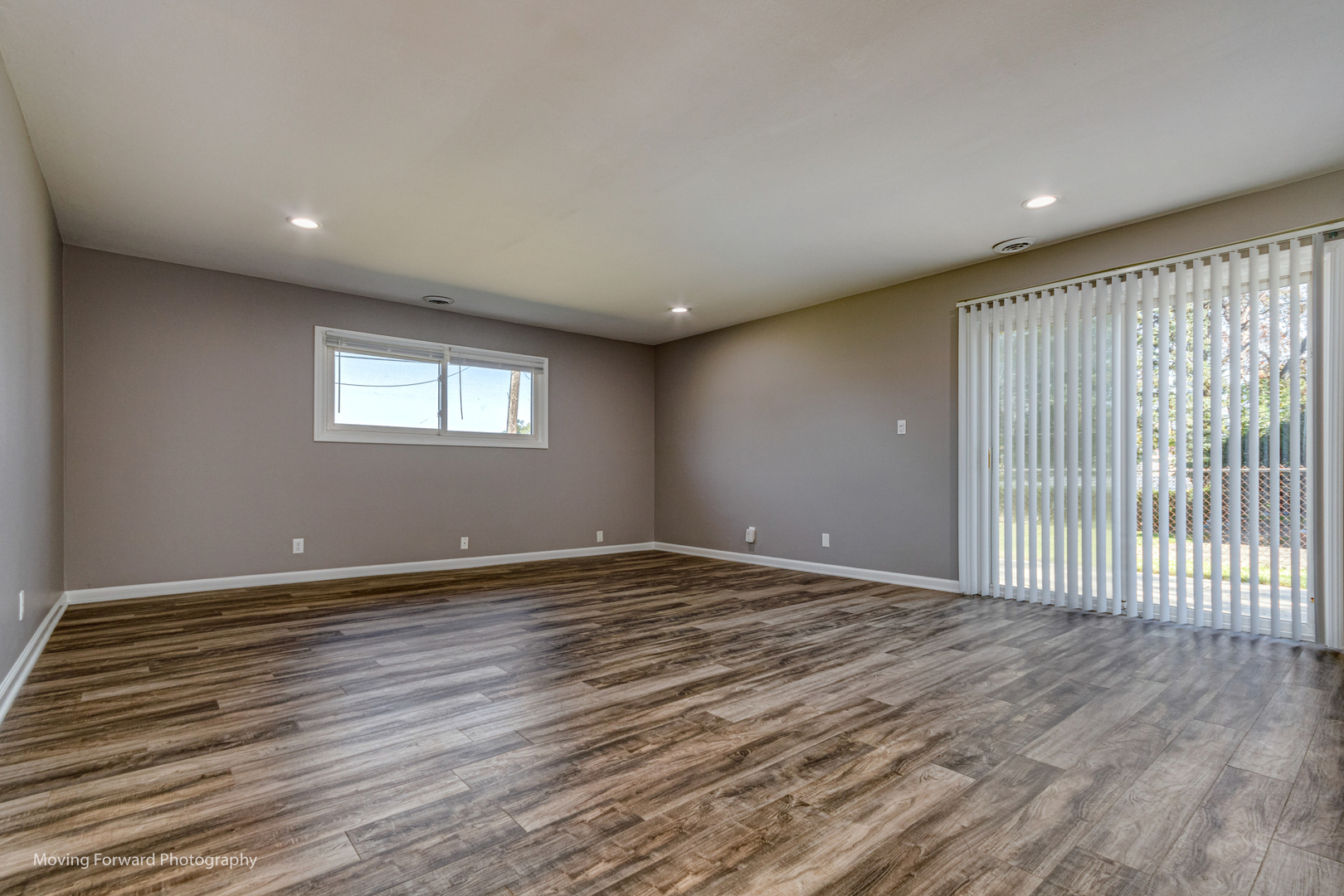 147 Queenswood Road Bolingbrook, IL 60440 - Photo 7 of 20 a view of an empty room with wooden floor and a window