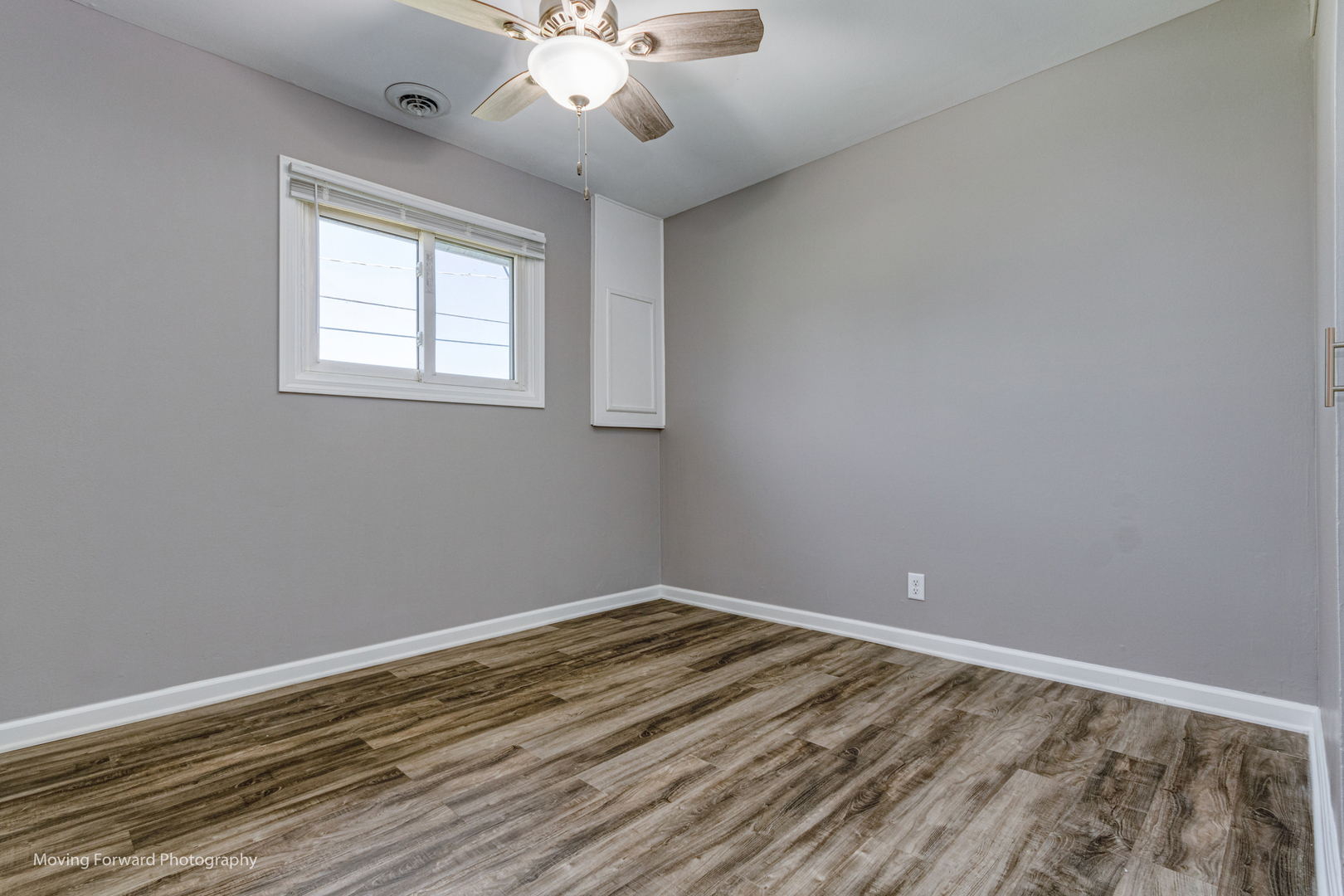 147 Queenswood Road Bolingbrook, IL 60440 - Photo 8 of 20 wooden floor in an empty room with a window