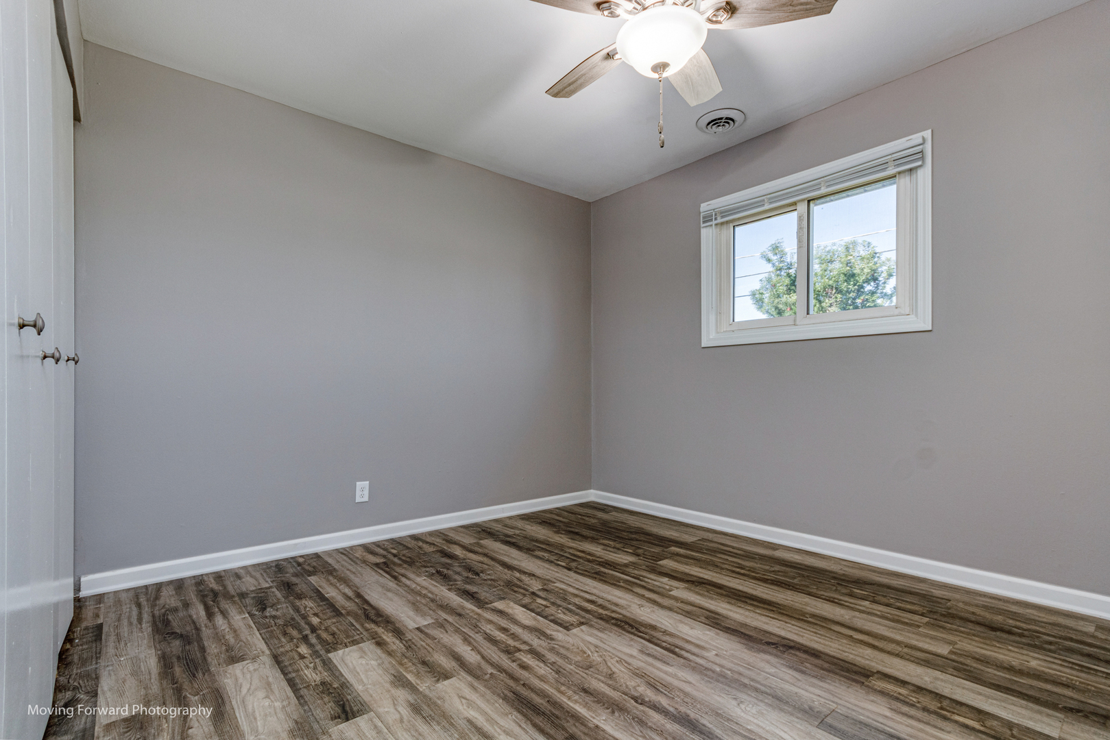 147 Queenswood Road Bolingbrook, IL 60440 - Photo 10 of 20 wooden floor in an empty room with a window