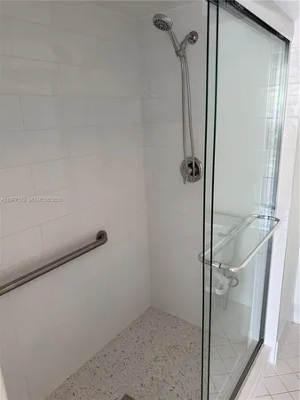 a bathroom with a glass shower door