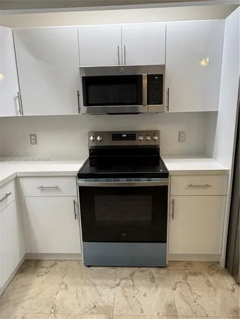 a kitchen with a stove and a microwave
