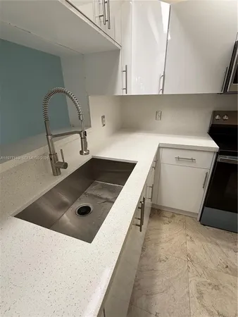 a kitchen with a stove and a sink