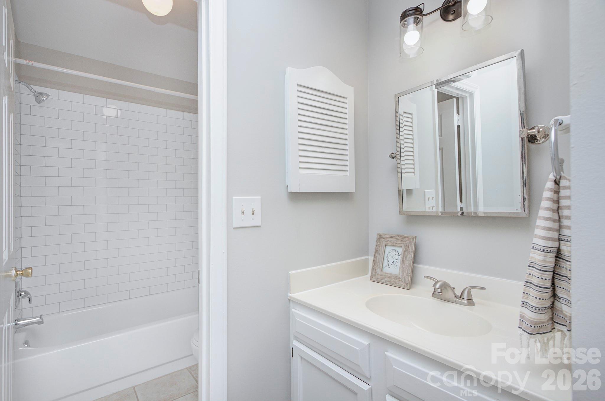 8268 Golf Ridge Drive Charlotte, NC 28277 - Photo 21 of 24 a bathroom with a sink vanity tub and shower